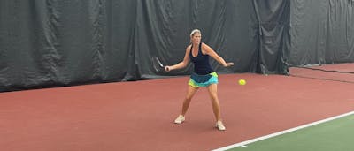 A tennis player hitting a Head Gravity Pro Racquet · Unstrung. 