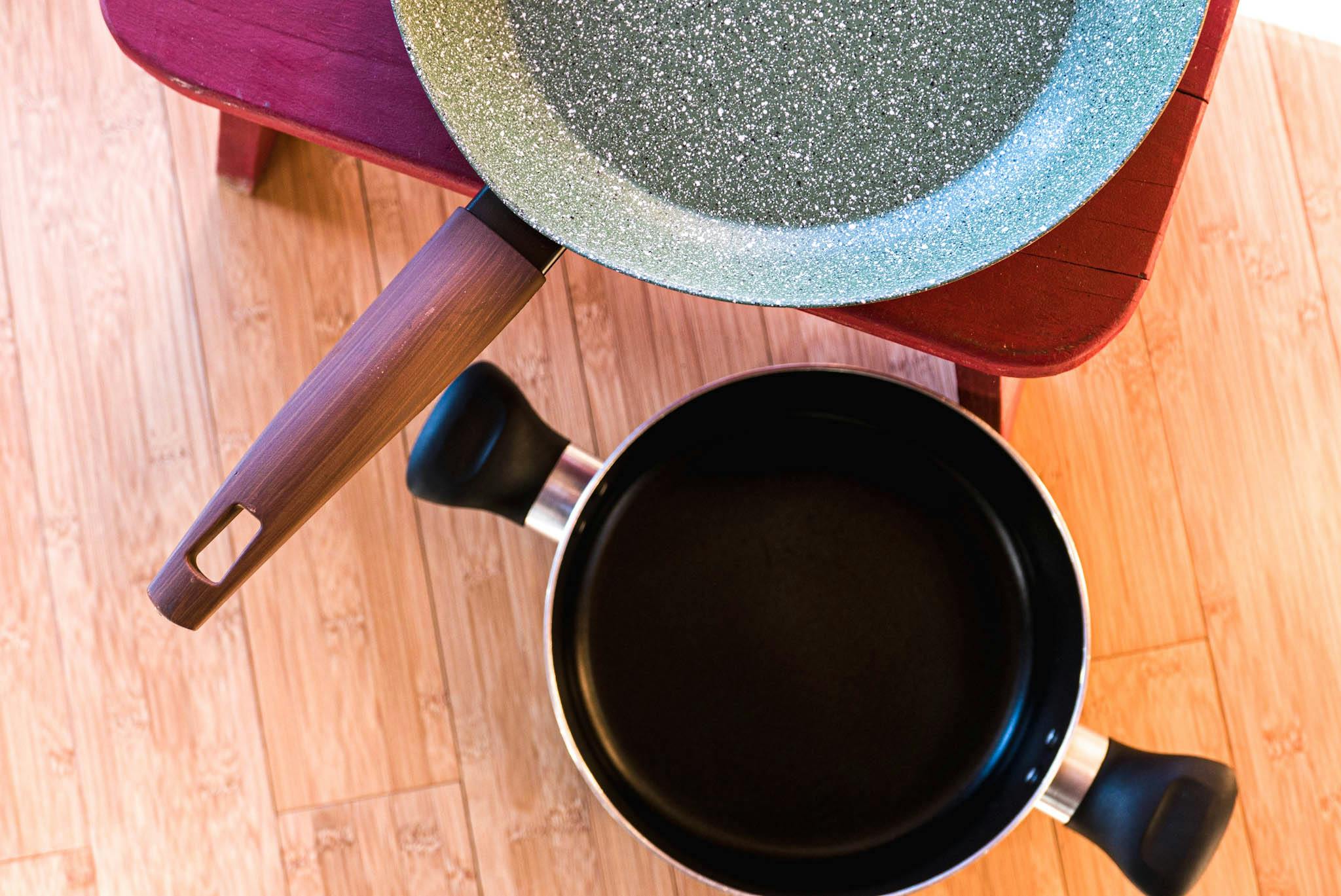 A ceramic pan sits next to a ceramic pot. 