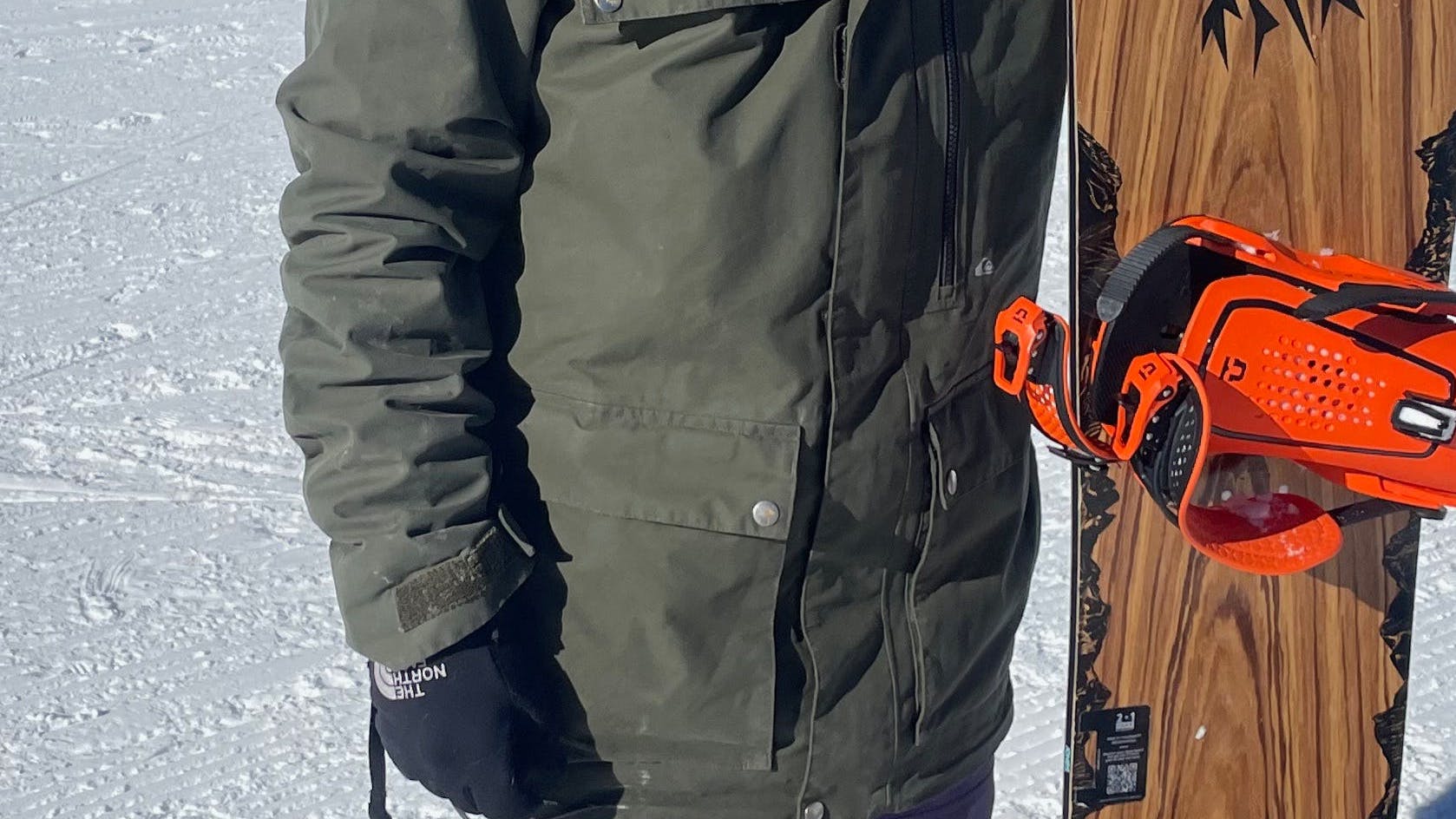 A snowboarder holding a snowboard mounted with the  Union Force  Snowboard Bindings · 2023. 