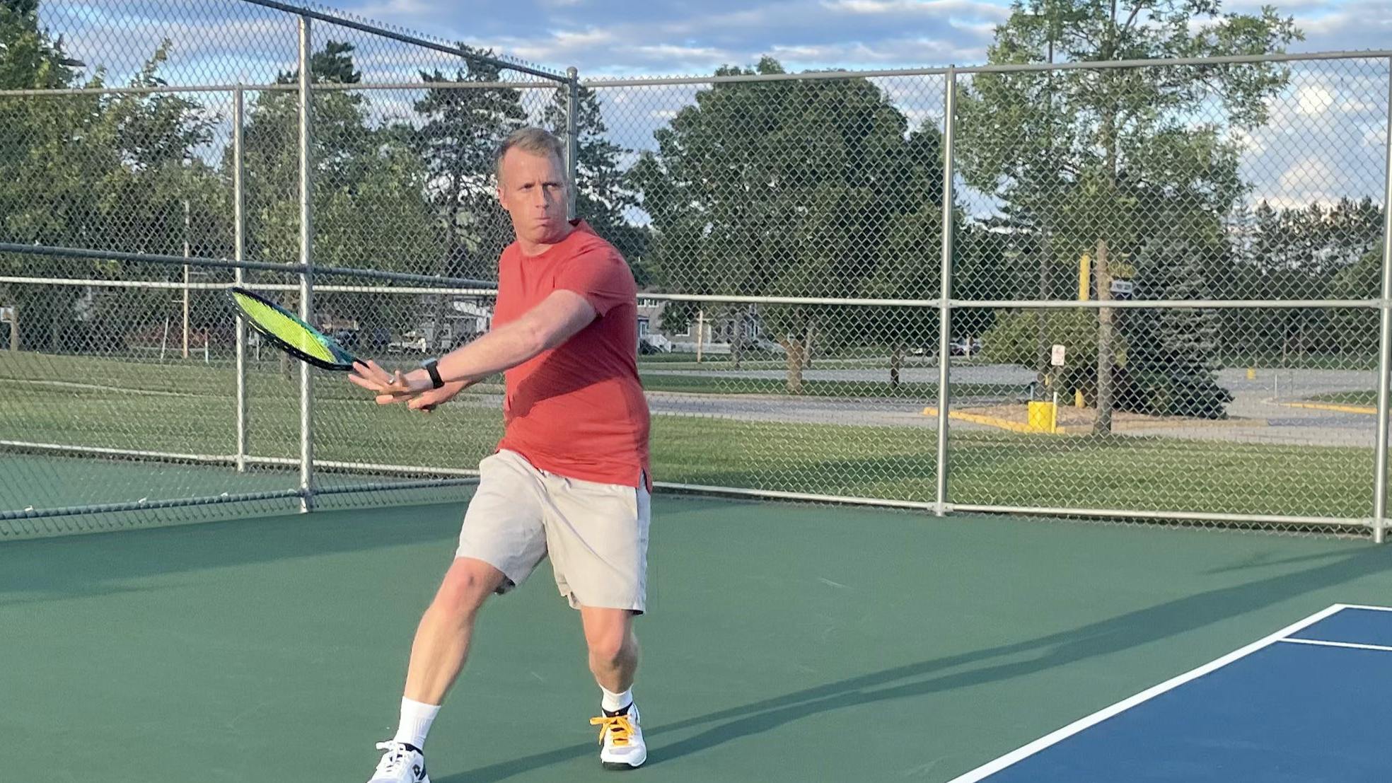 A man on a tennis court uses the Yonex VCORE Pro 97 Racquet.