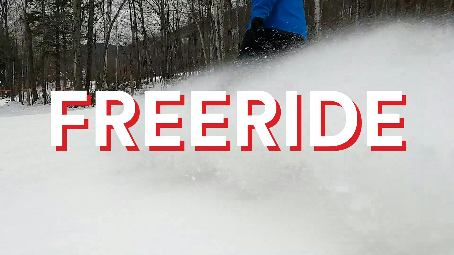 A snowboarder splashing a wave of snow with a "Freeride" graphic over the image