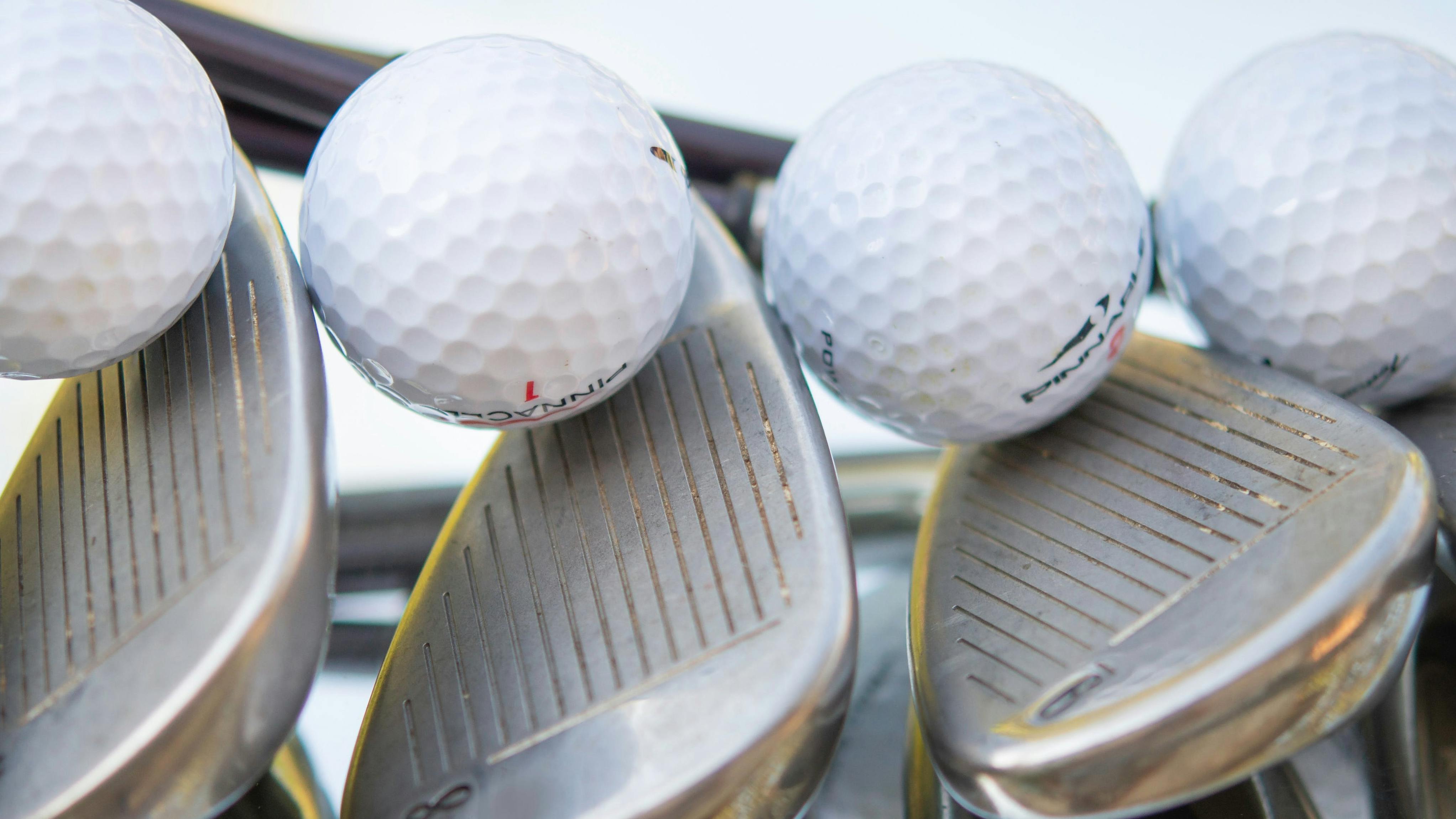 Golf clubs and balls with reflection 