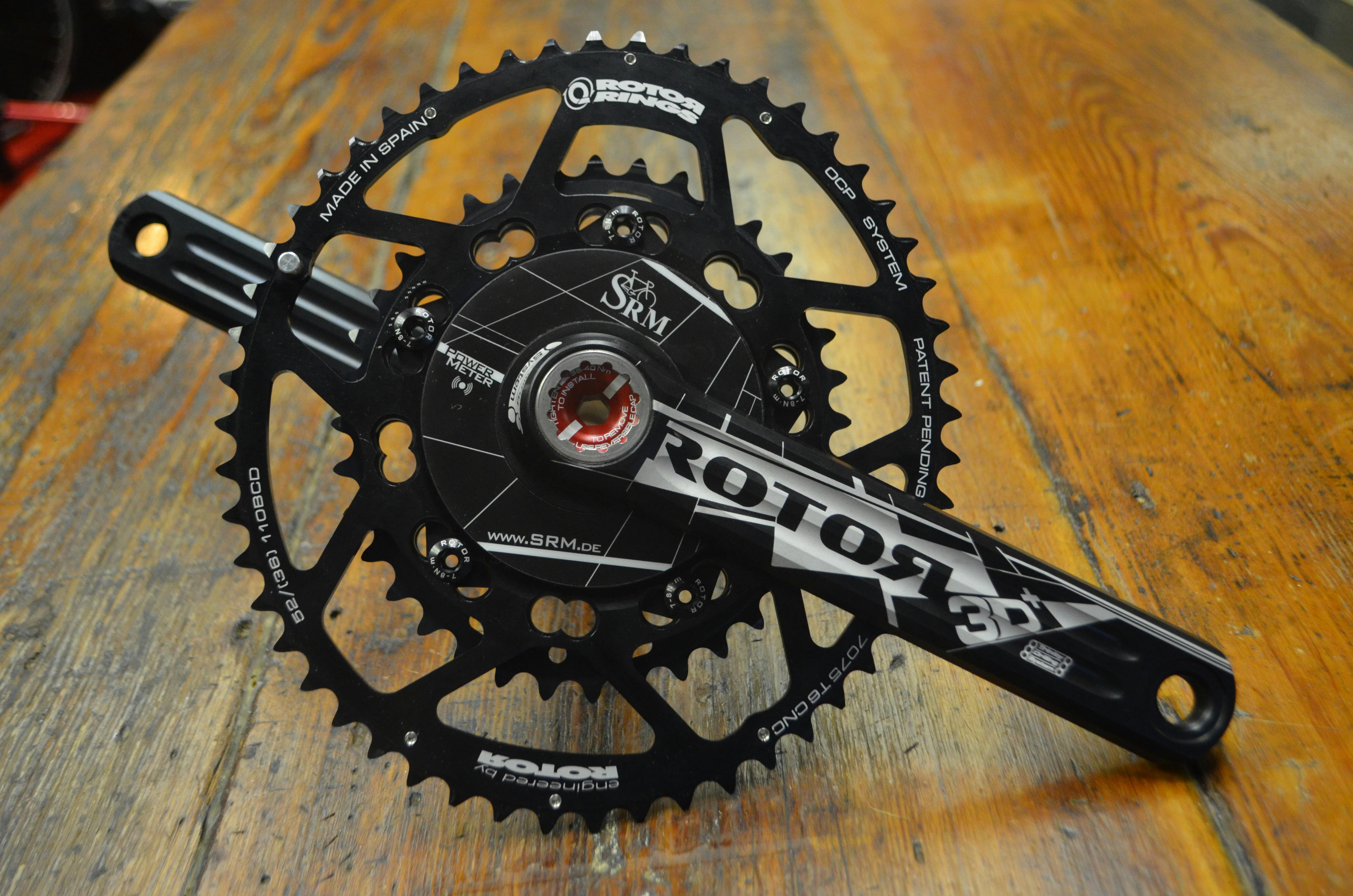 Rotor 3D SRM Crankset laying on a table. It is black.