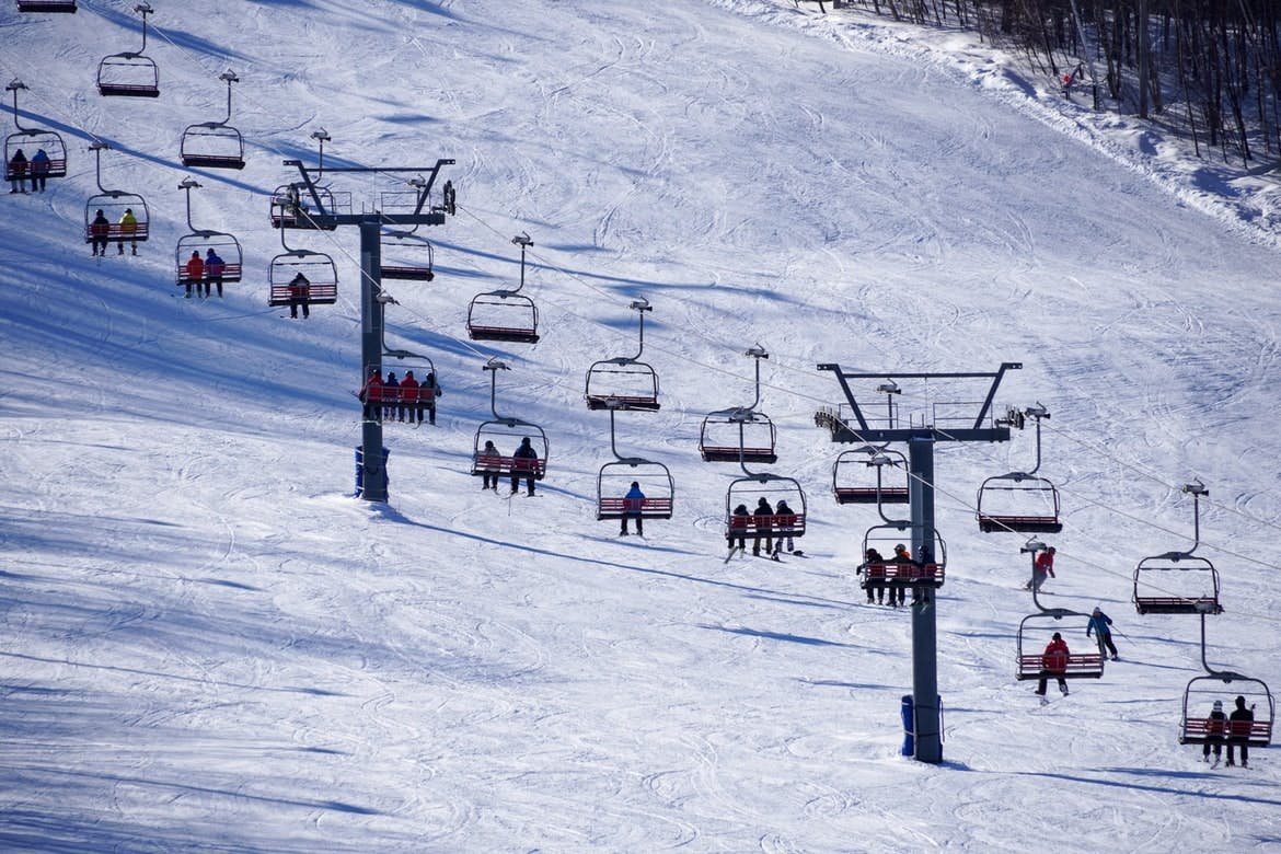 A chairlift takes skiers and snowboarders up the slope.