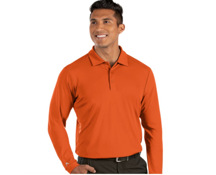 Man wearing the Antigua Men’s Long Sleeve Tribute Golf Shirt.