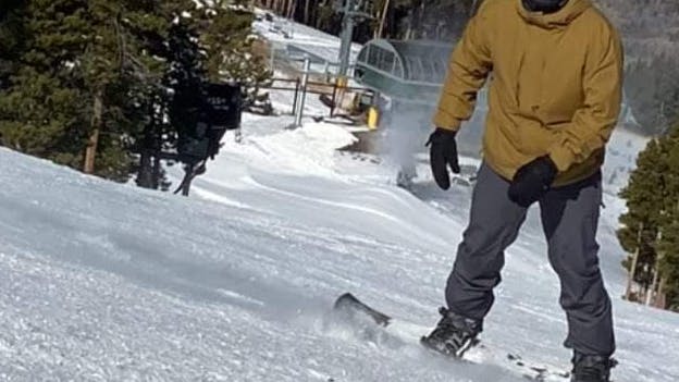 A snowboarder wearing the Volcom Men's Freakin Snow Chino Pants. 