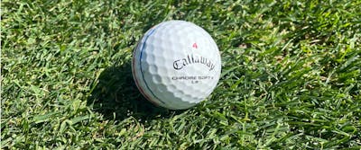 A Callaway 2022 Chrome Soft X LS Golf Ball on grass.