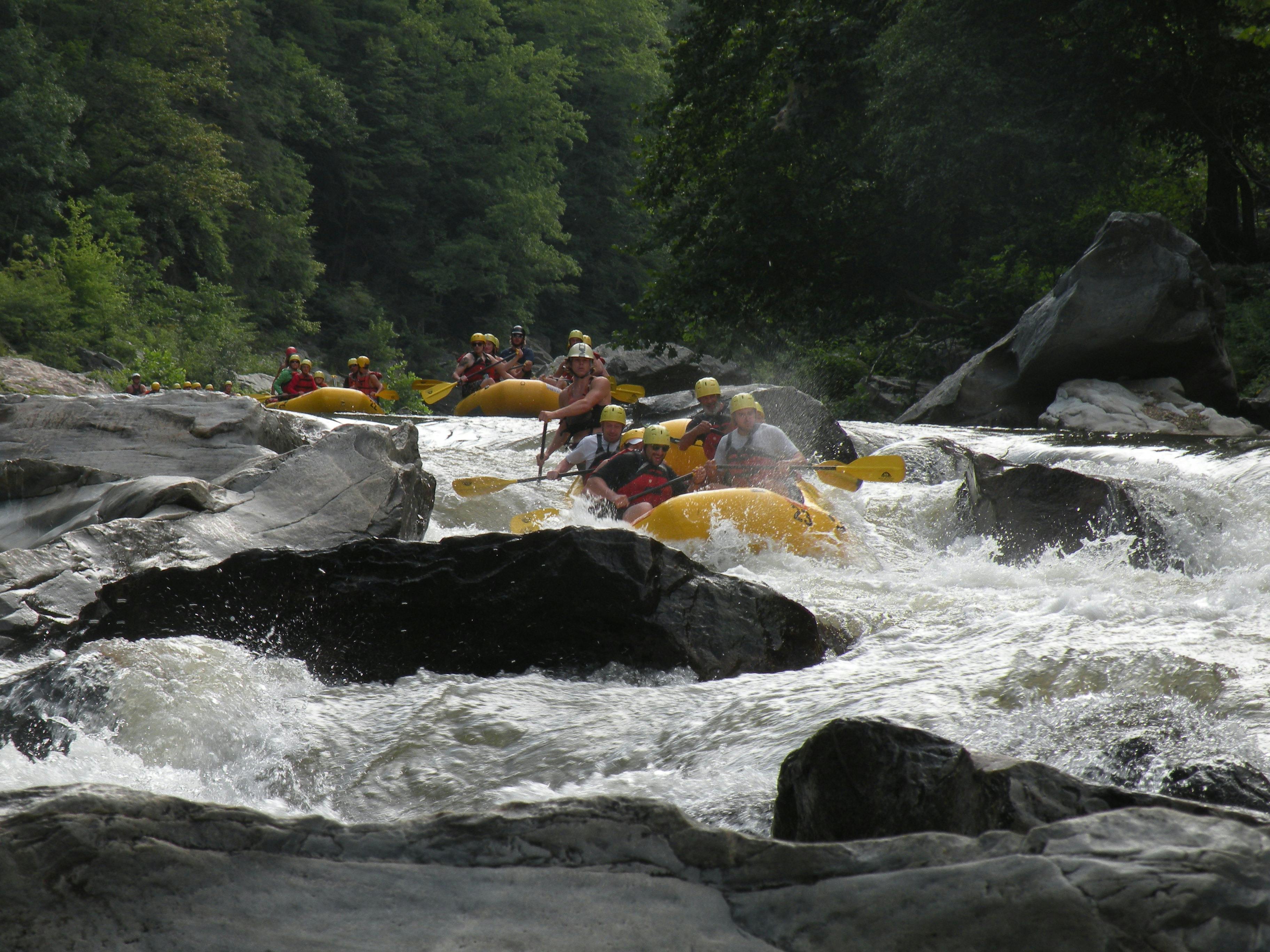 Multiple groups of whitewater rafters make their way down the Nolichucky River
