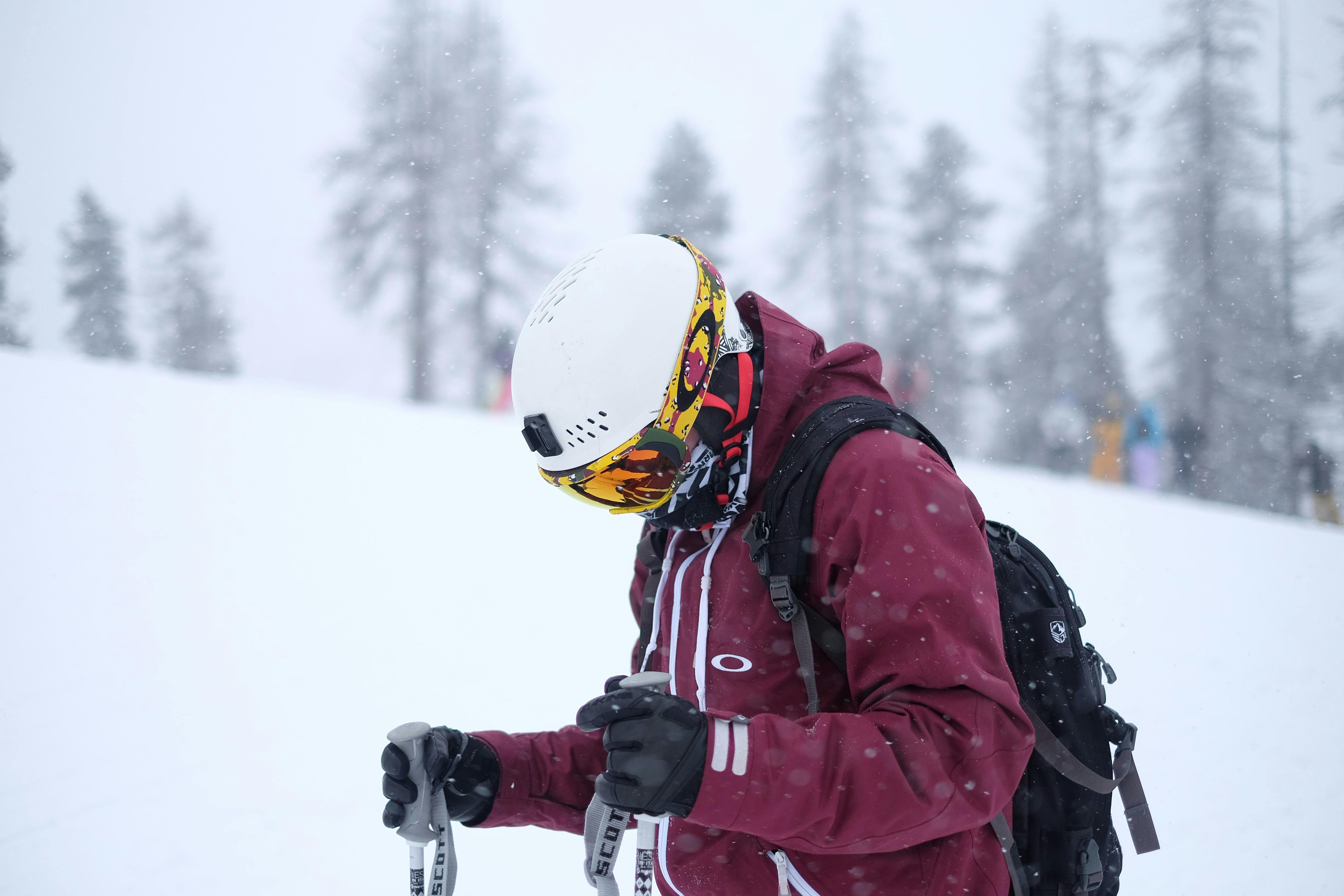 A skier wearing a helmet with a helmet mount. 