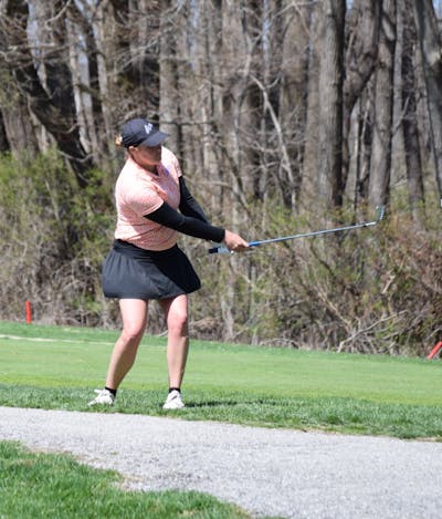 Woman uses the Callaway MD5 JAWS Wedge on a golf course.