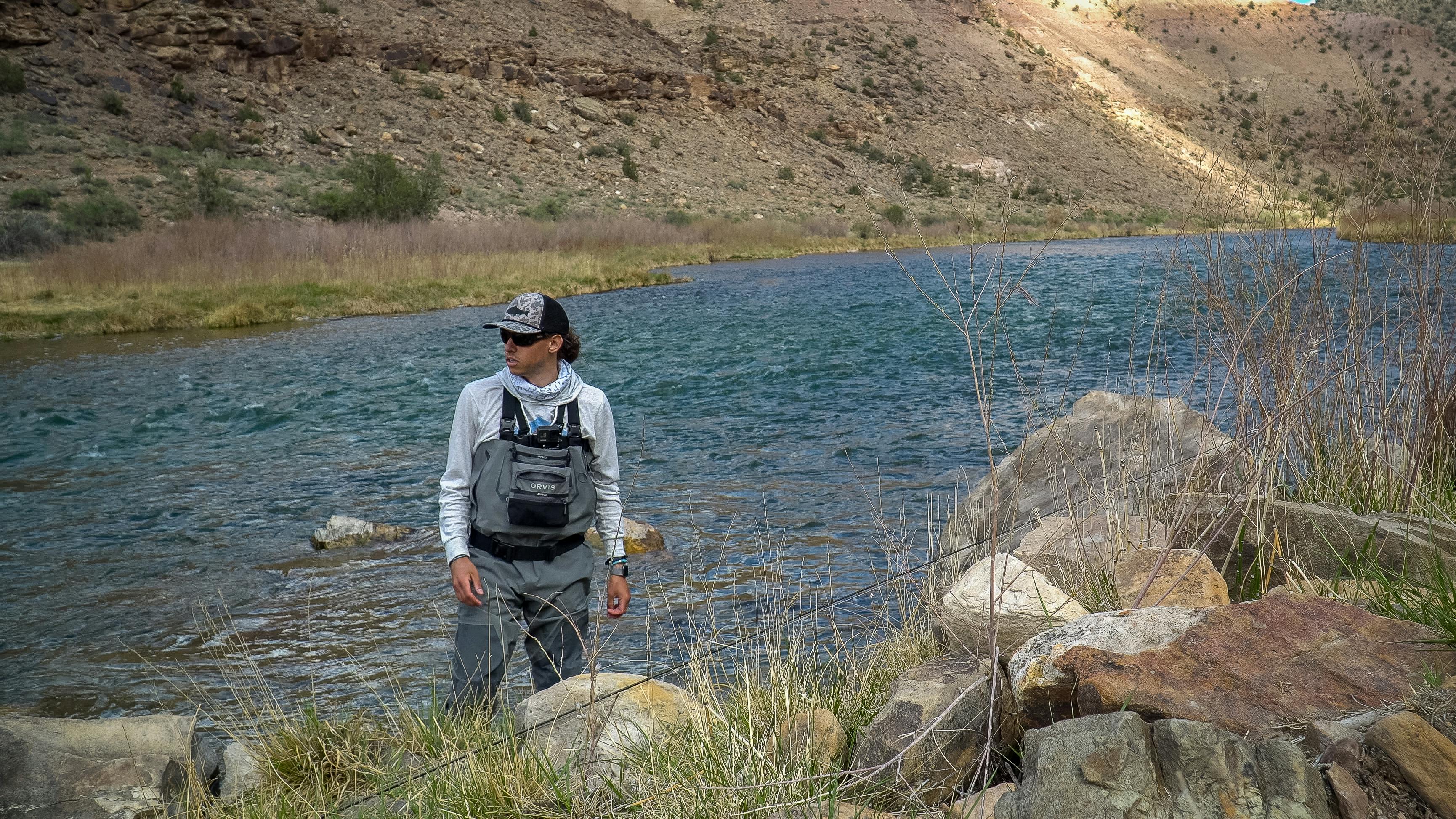 Someone standing in a river with the Orvis Men's PRO Waders.