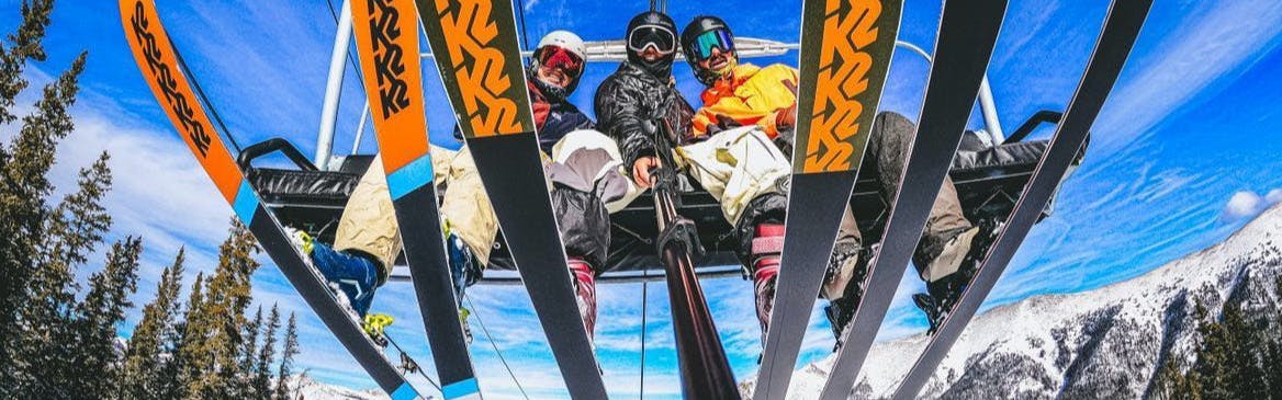 Ski Experts Allie Staffen, Jake Renner, and Hayden Wright sitting on a charlift.