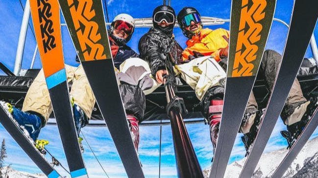 Ski Experts Allie Staffen, Jake Renner, and Hayden Wright sitting on a charlift.