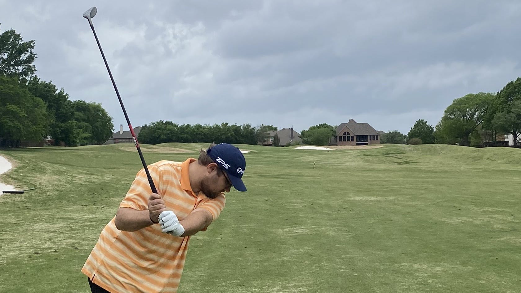 A man takes a swing with a golf club.