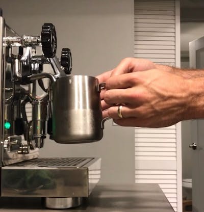 Someone using the milk steaming feature on the Rocket Espresso Appartamento Espresso Machine.