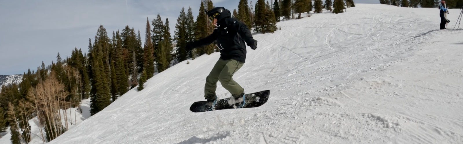 Curated Snowboard Expert Everett Pelkey jumping with the 2023 Jones Mountain Twin snowboard