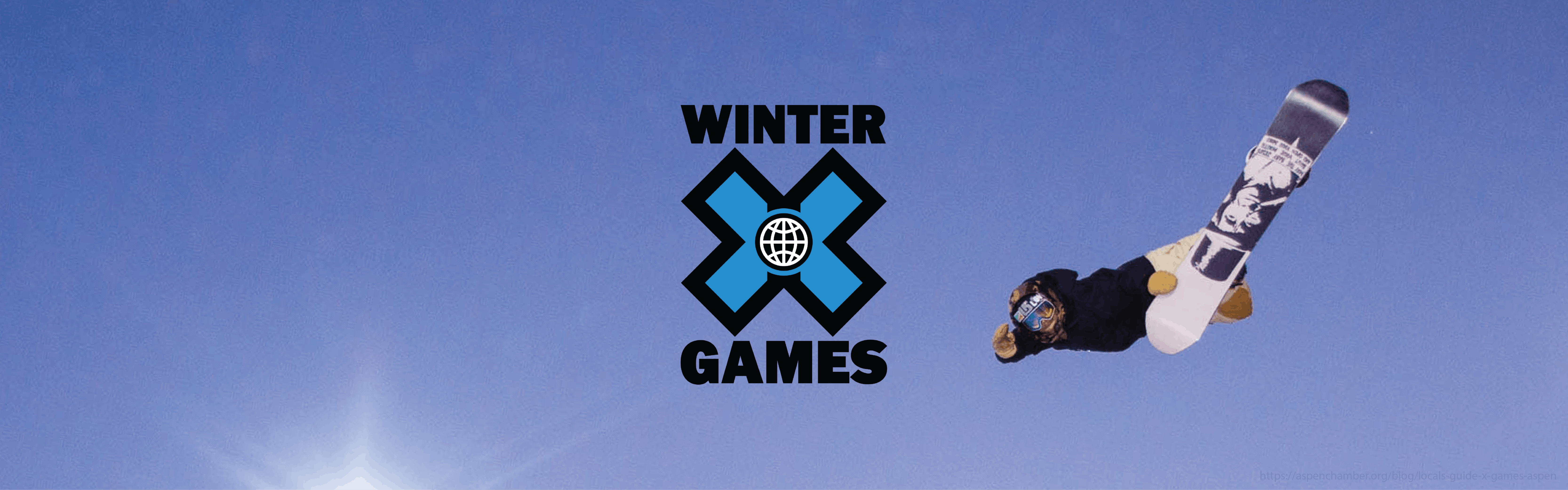 A snowboarder jumps against a blue sky with an added Winter X Games logo on top of the image.