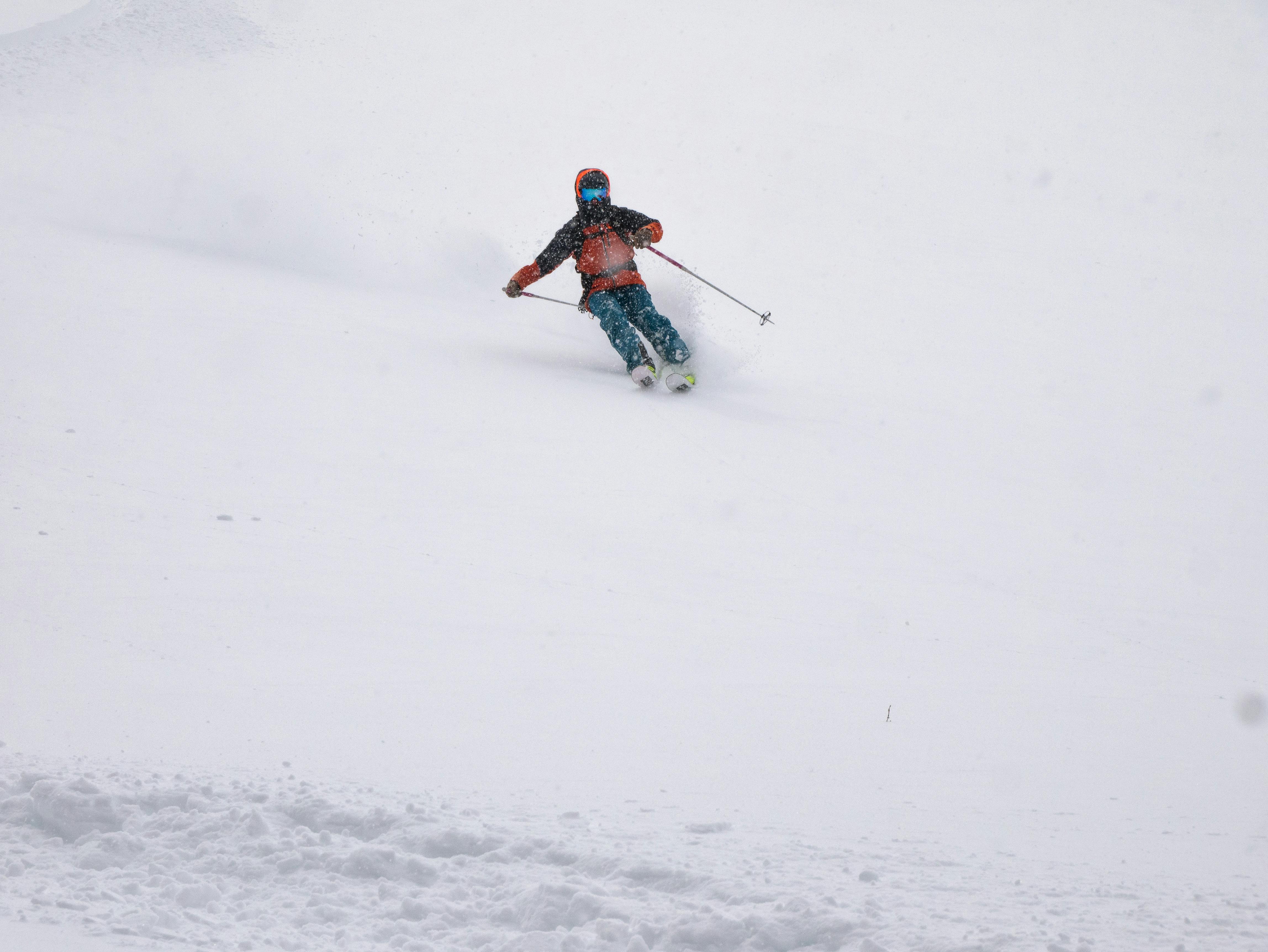 A skier turning down a mountain. 