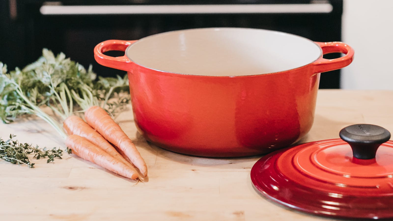 A Le Creuset pot with carrots. 