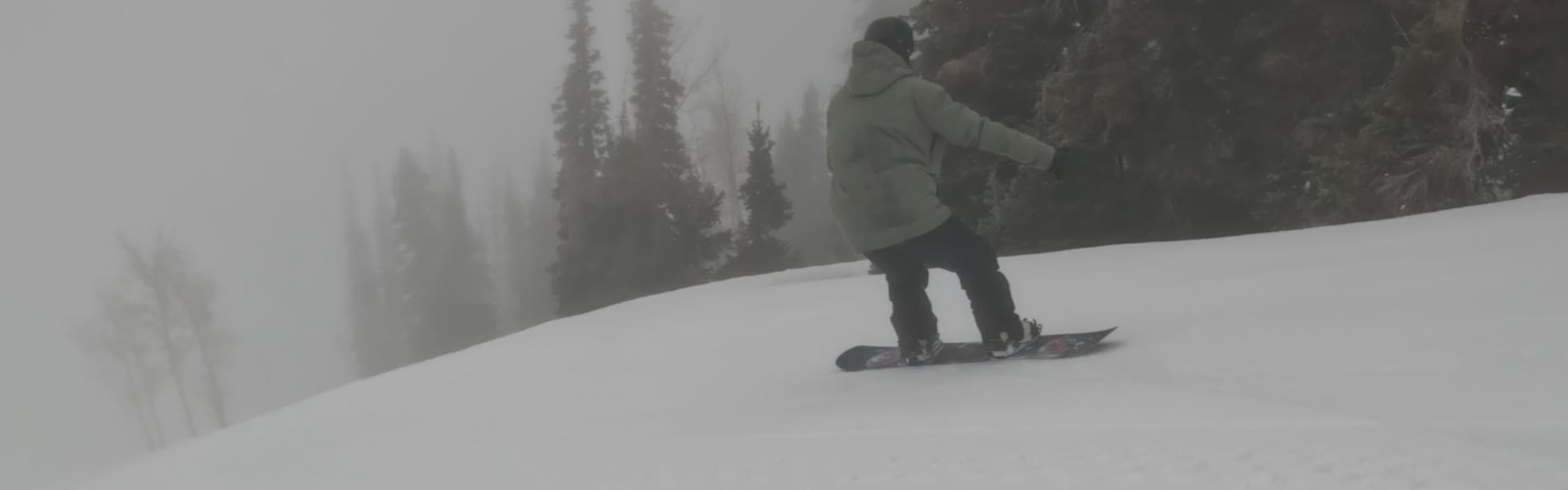 A snowboarder on the 2023 Never Summer Proto Slinger Snowboard.