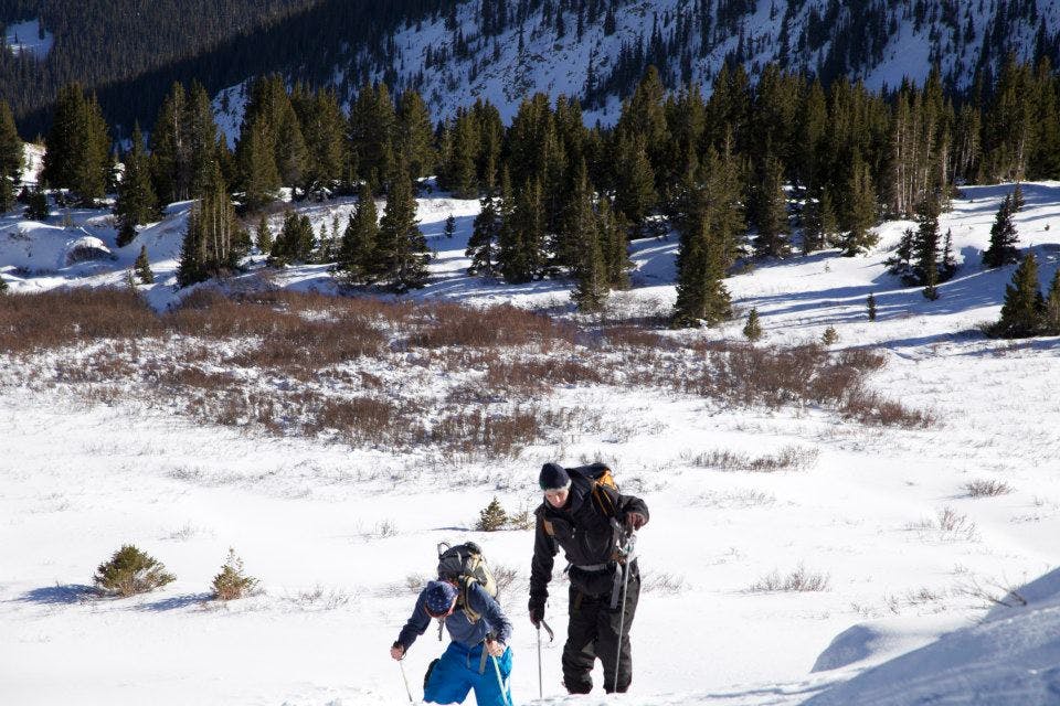 Two people hike through the backcountry