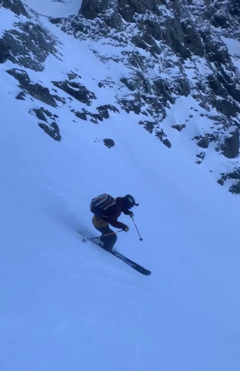 A skier turning down a ski mountain on the Armada 108 skis. 