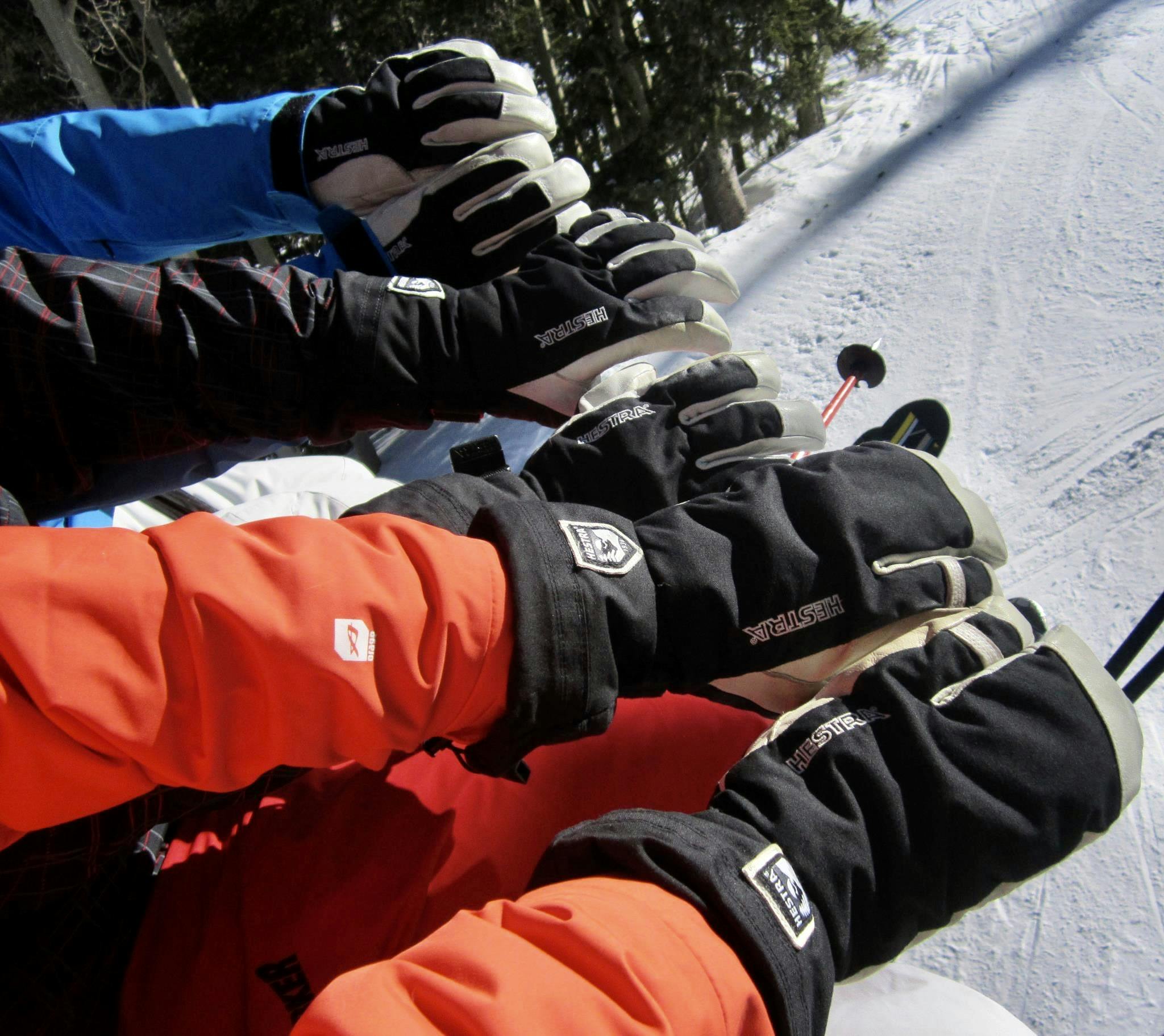 The Hestra Army Leather Heli Ski Gloves on a ski lift.