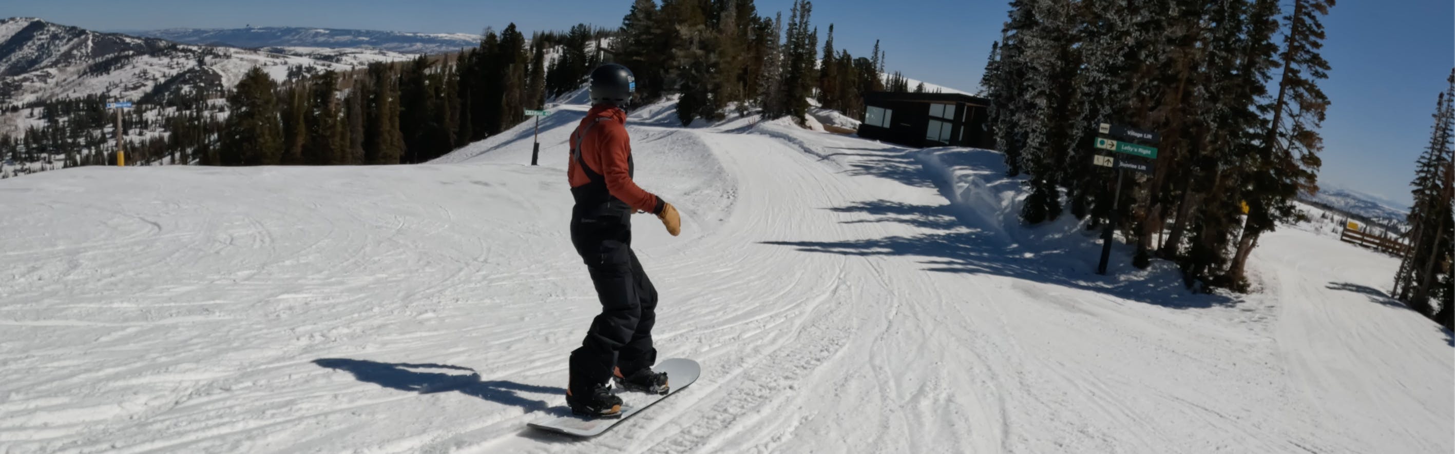 A snowboarder riding the Burton StoryBoard Snowboard.