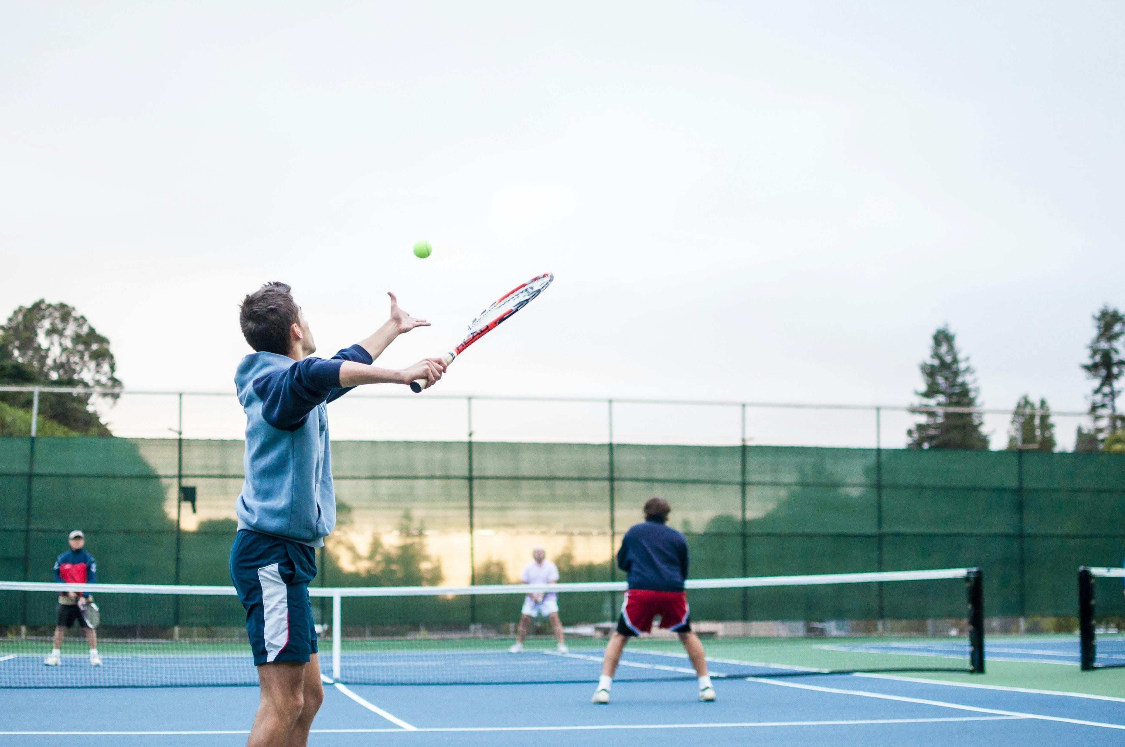 A tennis player hitting a ball with a racquet. 