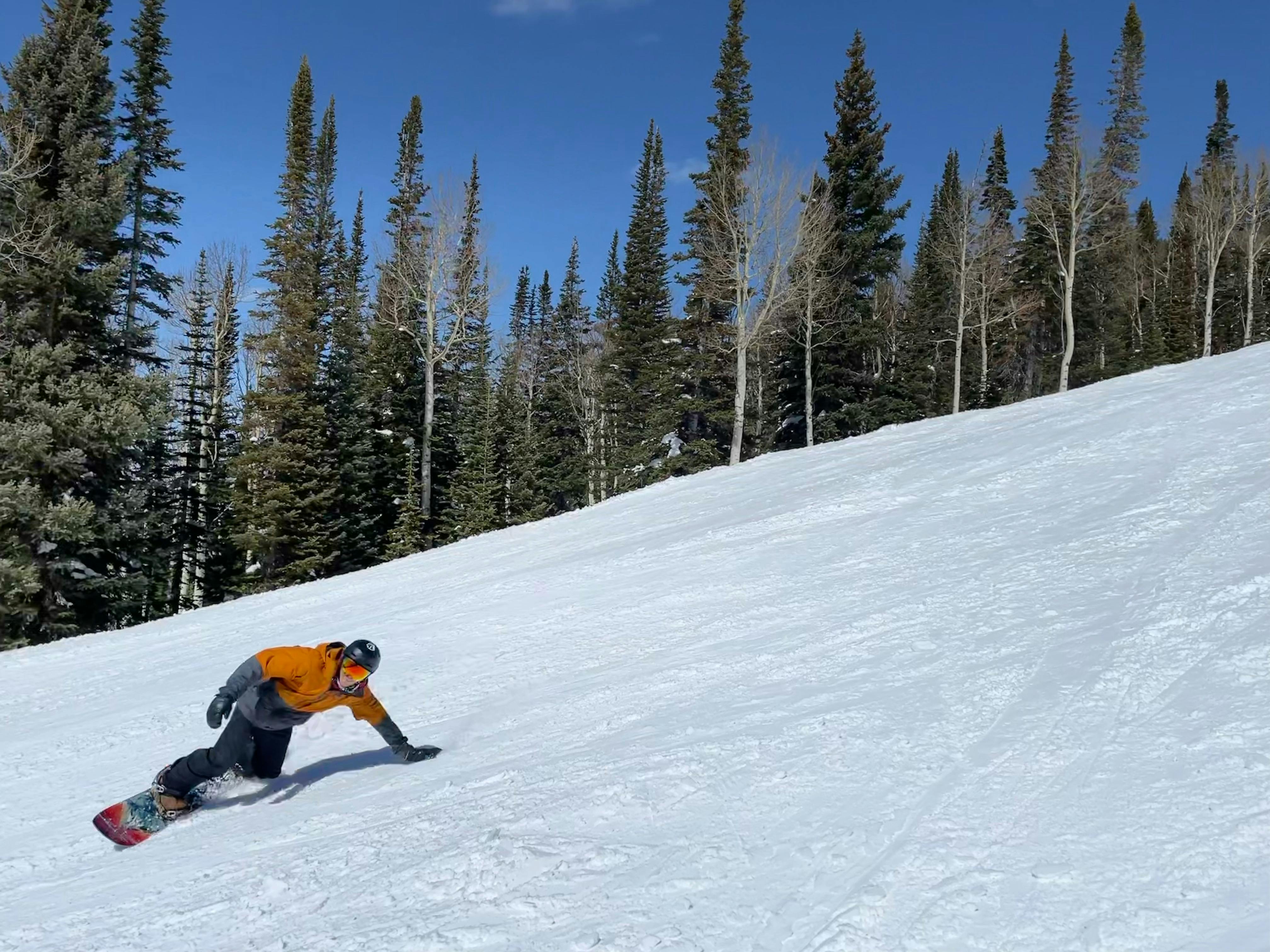 A snowboarder carving down a hill in the K2 Maysis Snowboard Boots · 2022. 