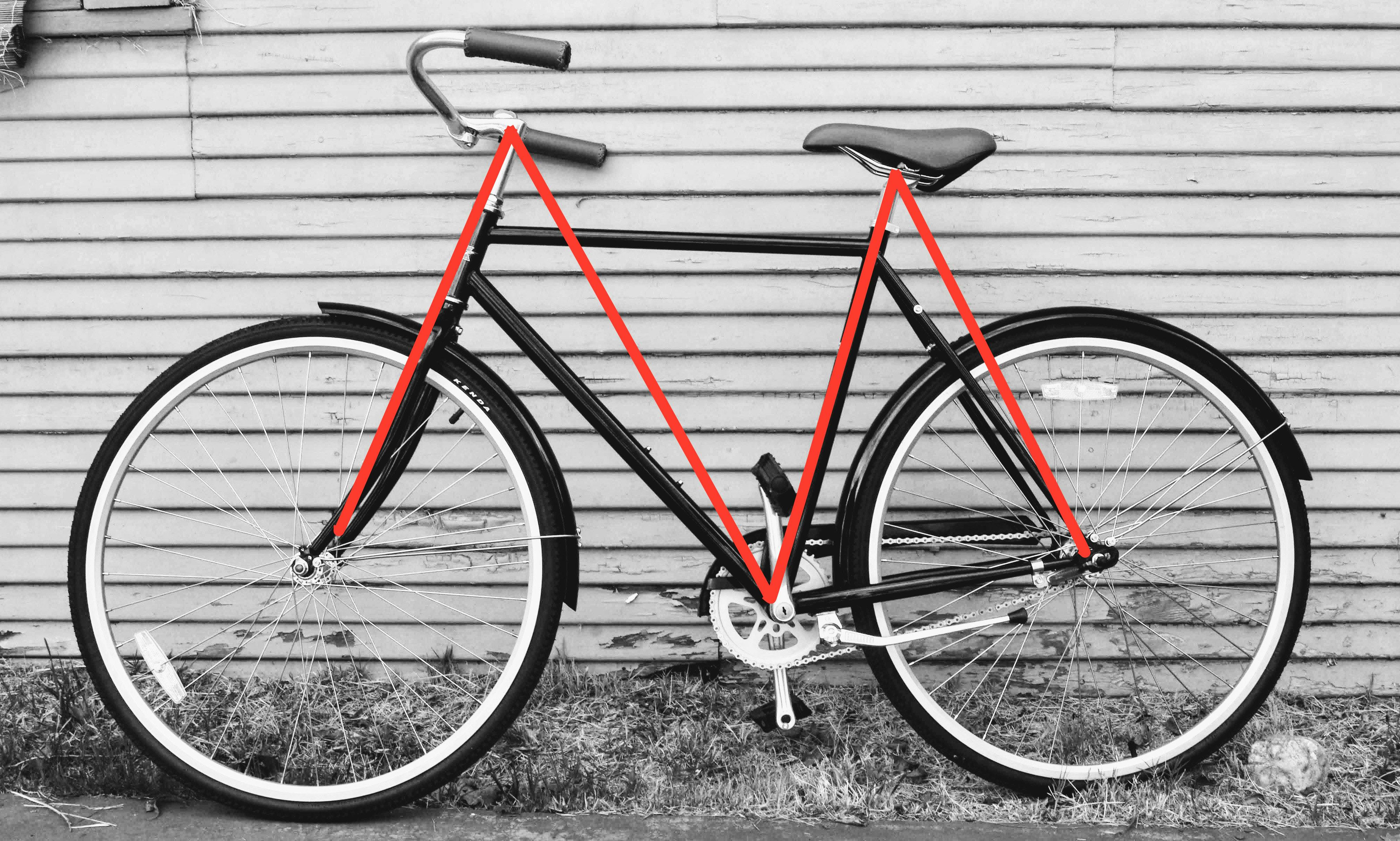 A black-and-white photo of a bike with a red M super-imposed over it