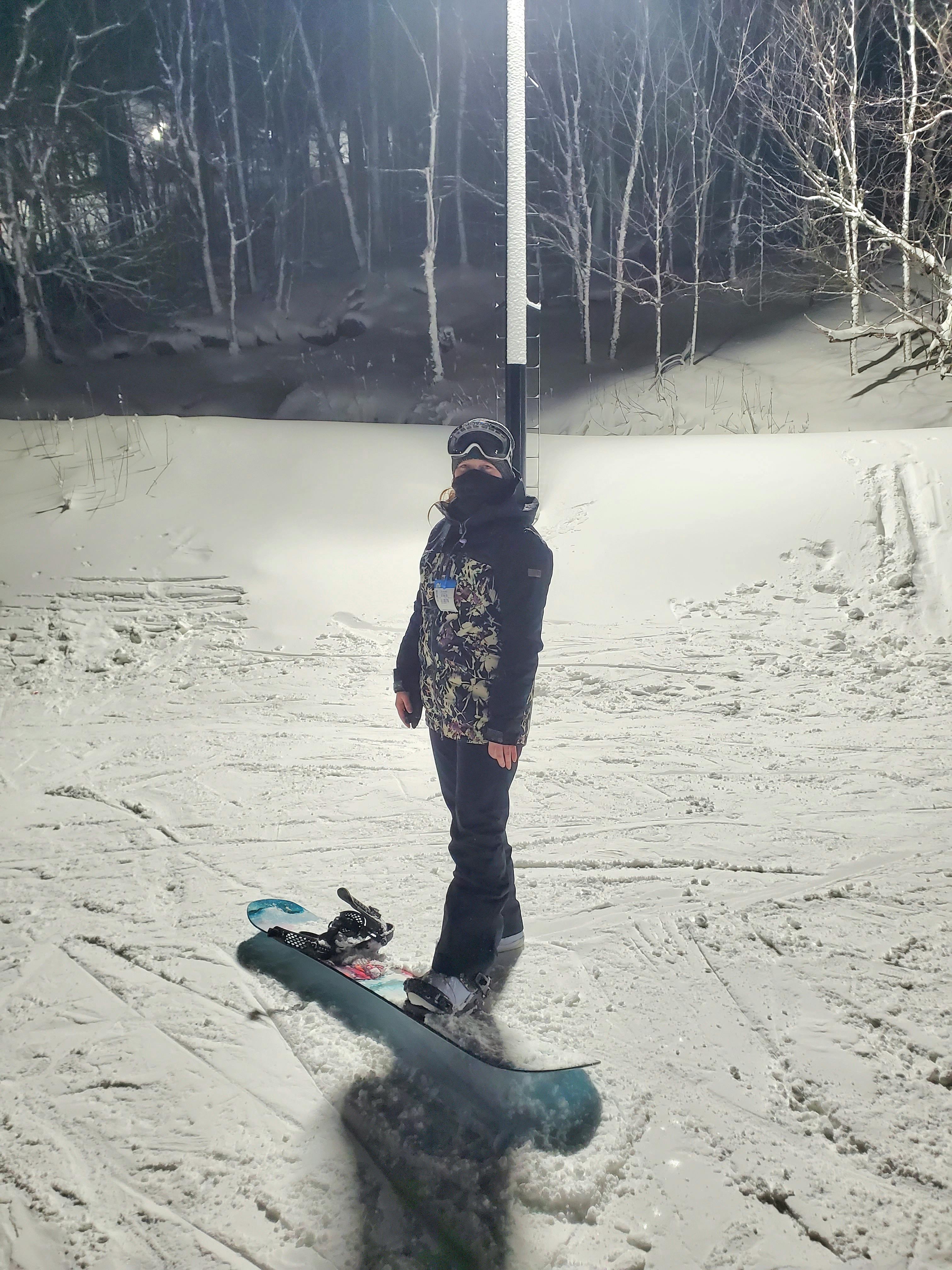 A snowboarder standing in the Roxy Women's Backyard Pants.