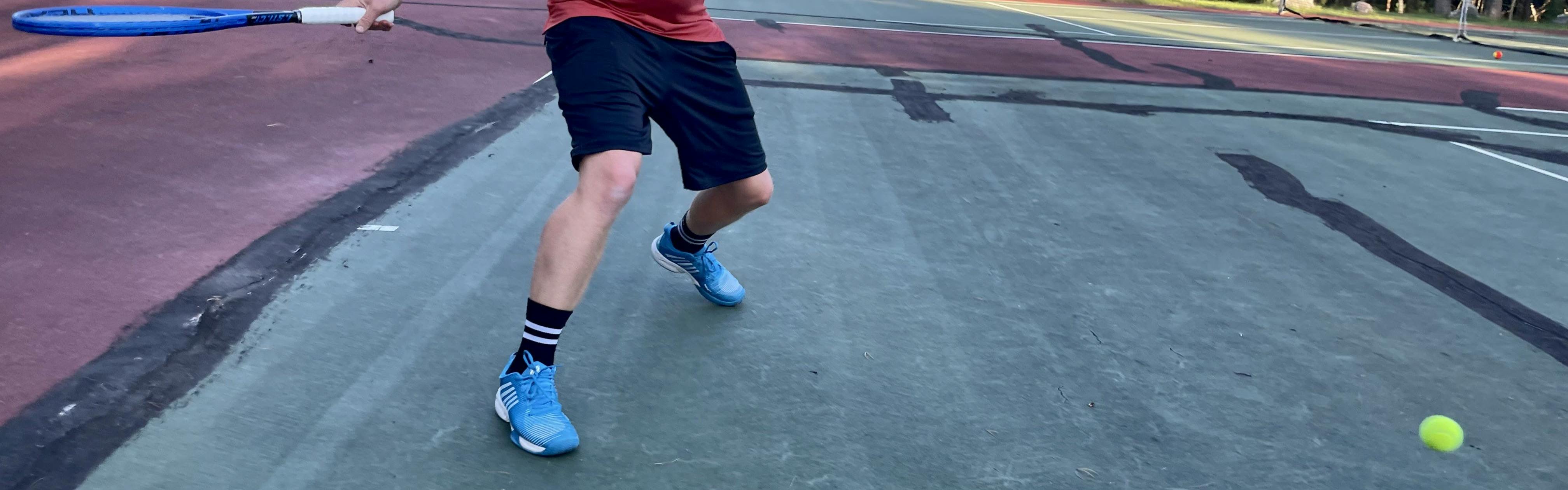 A tennis player in the  K-Swiss Men's Hypercourt Supreme Tennis Shoes.