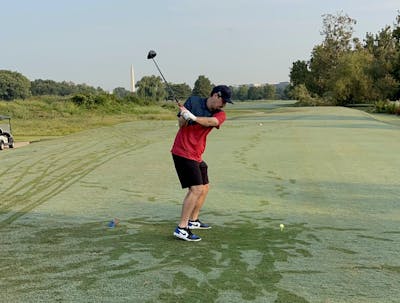 A man golfing with the  Srixon ZX5 Driver.