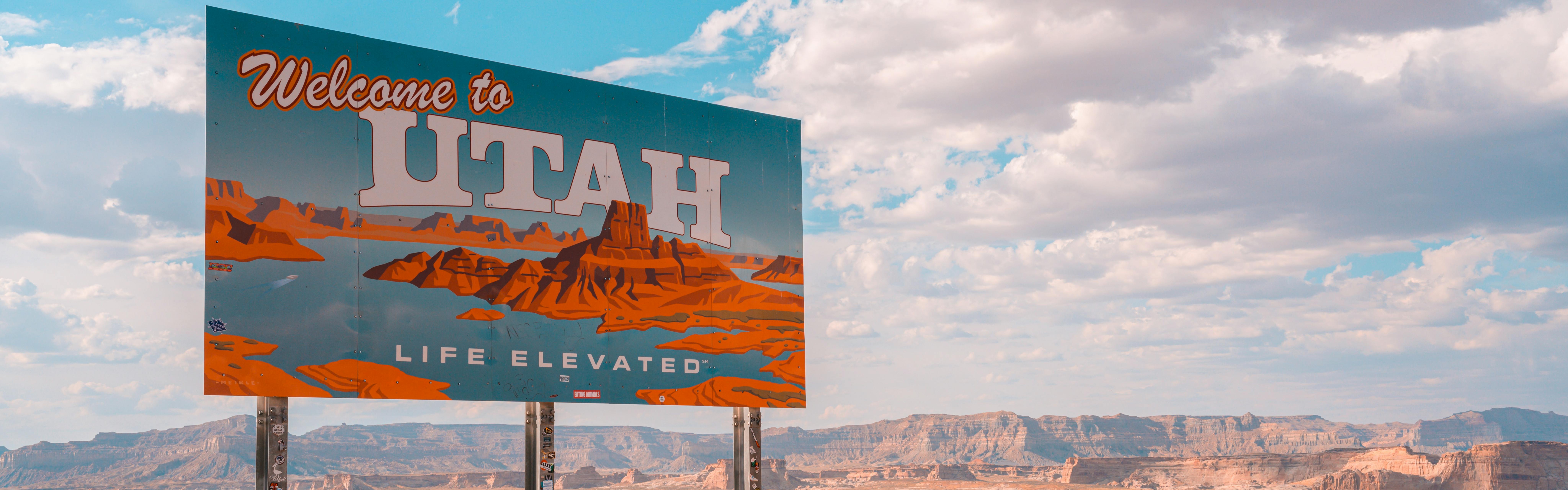 A roadside sign reads "Welcome to Utah. Life Elevated." 