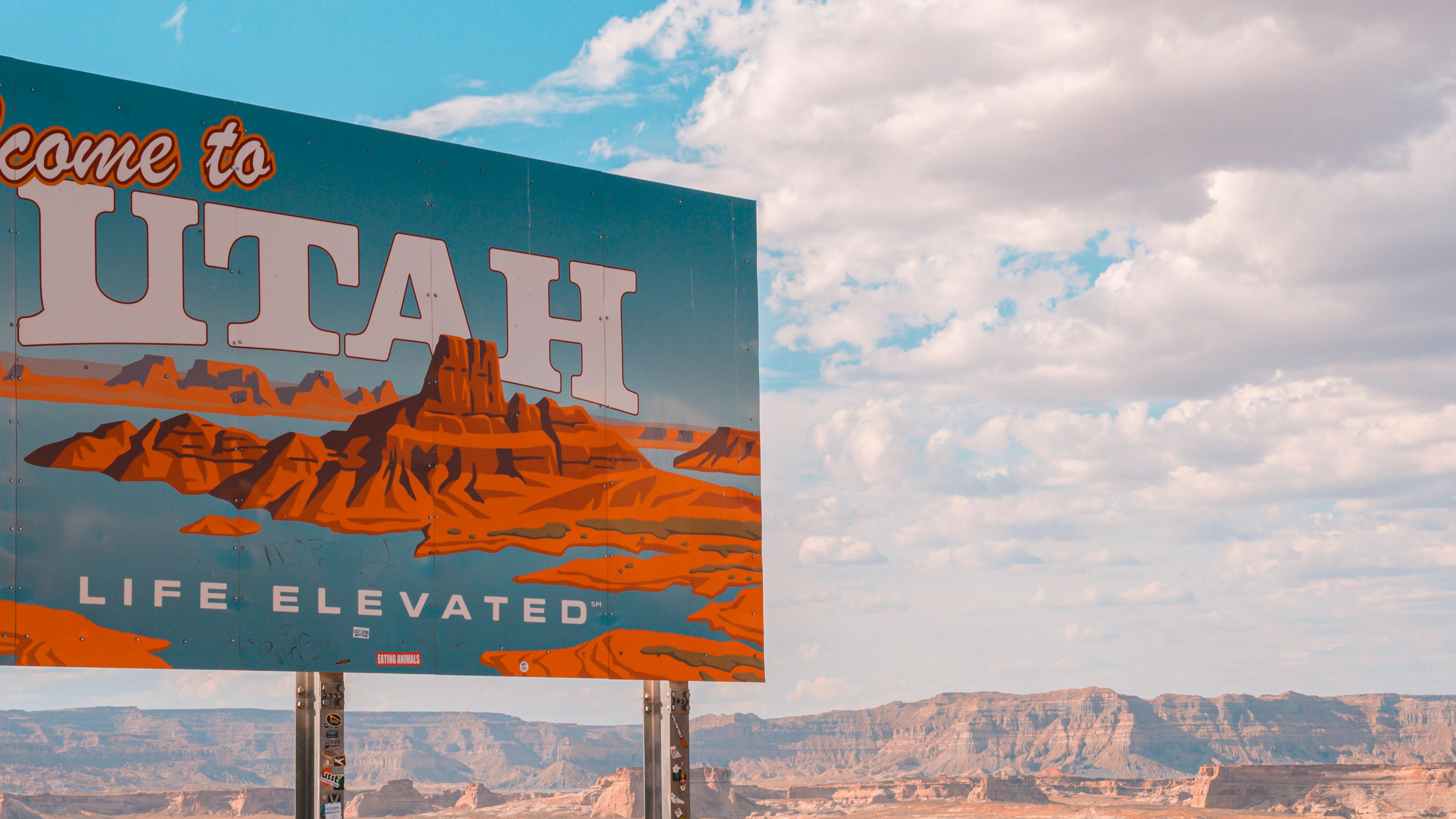A roadside sign reads "Welcome to Utah. Life Elevated." 
